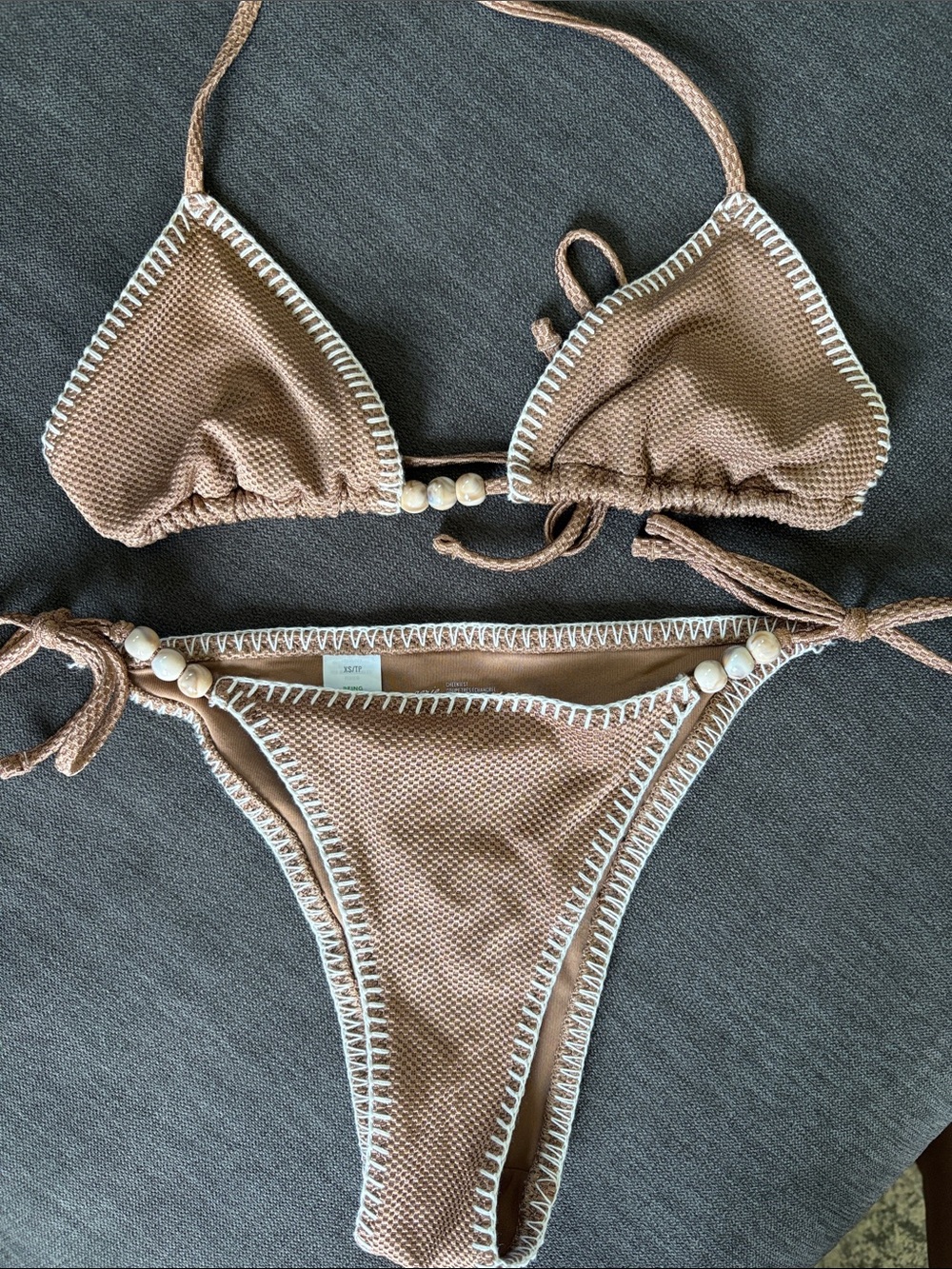 aerie tan bikini with white trim and bead accents